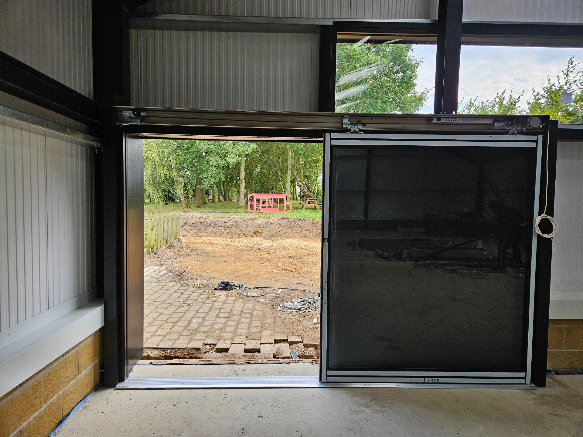 Automatic aluminium sliding door installation from inside the building – Prestige Aluminium Systems