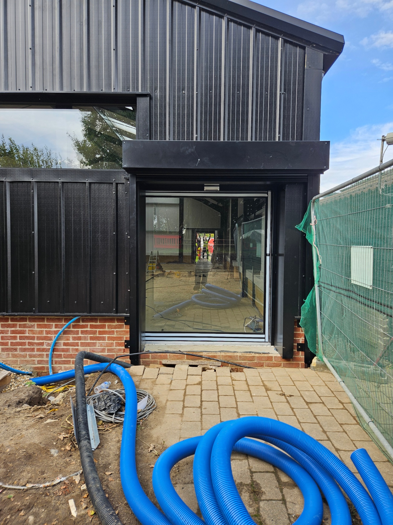 Black aluminium electric sliding door installation – Prestige Aluminium Systems